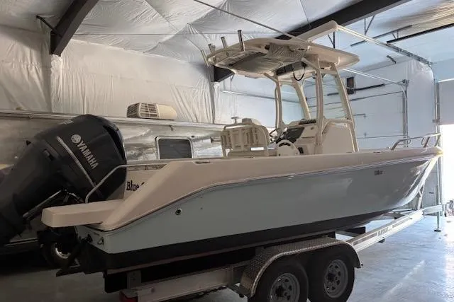 The Image of 2013 Everglades 230 Center Console boat on trailer in storage facility. - 0