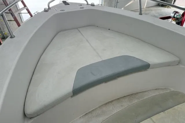 Slide: The Image of 2013 Everglades 230 Center Console boat interior with cushioned seating area. - 15