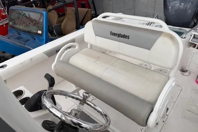Slide: The Image of 2013 Everglades 230 Center Console boat interior with steering wheel and seating. - 18