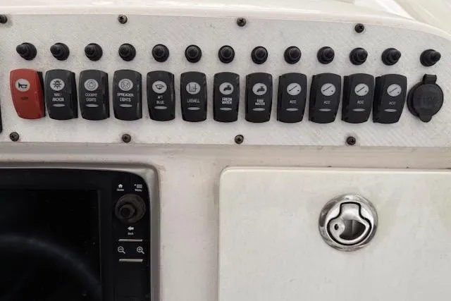 Slide: The Image of Control panel of a 2013 Everglades 230 Center Console boat with labeled switches. - 23