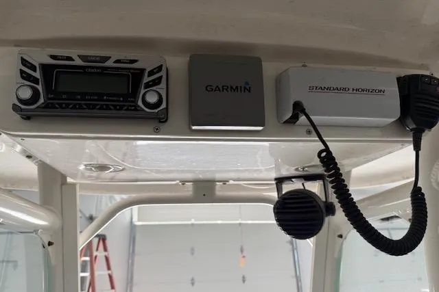 Slide: The Image of 2013 Everglades 230 Center Console boat electronics, featuring Garmin and Standard Horizon devices. - 24