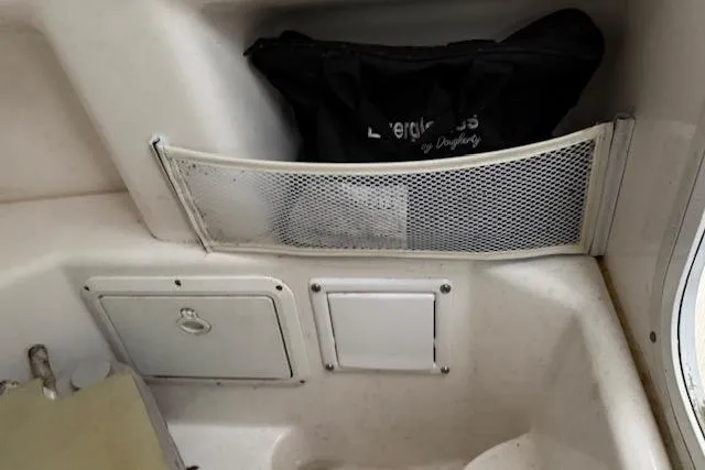 Slide: The Image of 2013 Everglades 230 Center Console interior storage compartments and mesh pocket. - 31