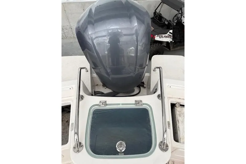 Slide: The Image of 2013 Everglades 230 Center Console boat with engine and storage compartment. - 33