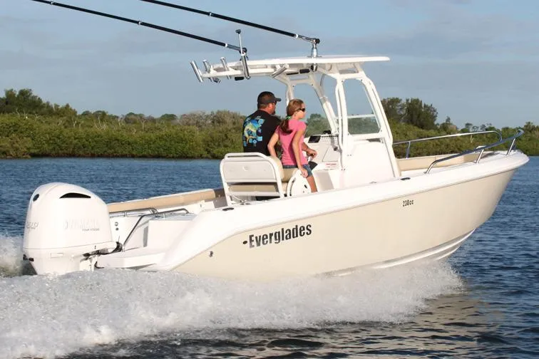 Slide: The Image of 2013 Everglades 230 Center Console boat in storage, showcasing sleek design and spacious deck. - 5