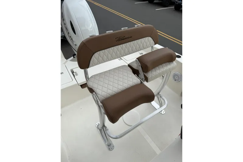 Slide: The Image of 2023 Pioneer 220 Bay Sport boat seat with brown and white quilted upholstery. - 10