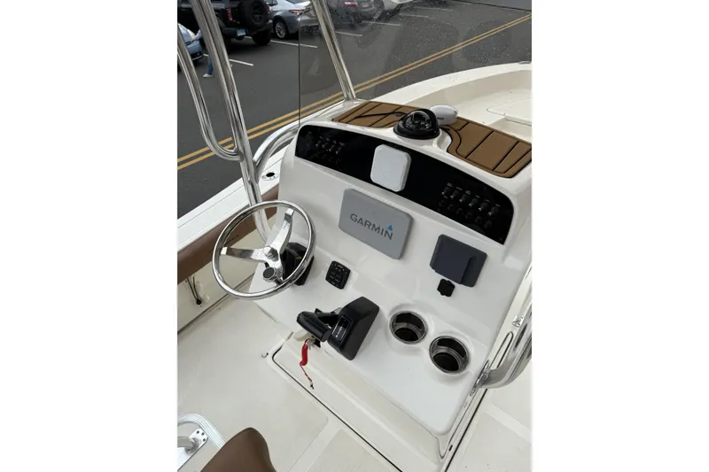Slide: The Image of 2023 Pioneer 220 Bay Sport boat console with Garmin navigation system and steering wheel. - 12