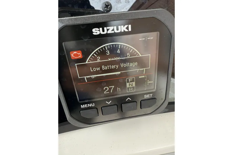 Slide: The Image of Suzuki display showing low battery voltage warning on 2023 Pioneer 220 Bay Sport boat. - 16