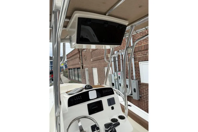 Slide: The Image of 2023 Pioneer 220 Bay Sport boat console with steering wheel and electronics. - 23