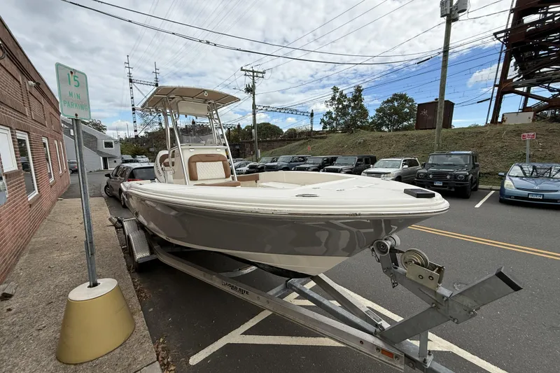 Slide: The Image of 2023 Pioneer 220 Bay Sport boat on trailer in parking lot, overcast sky. - 3