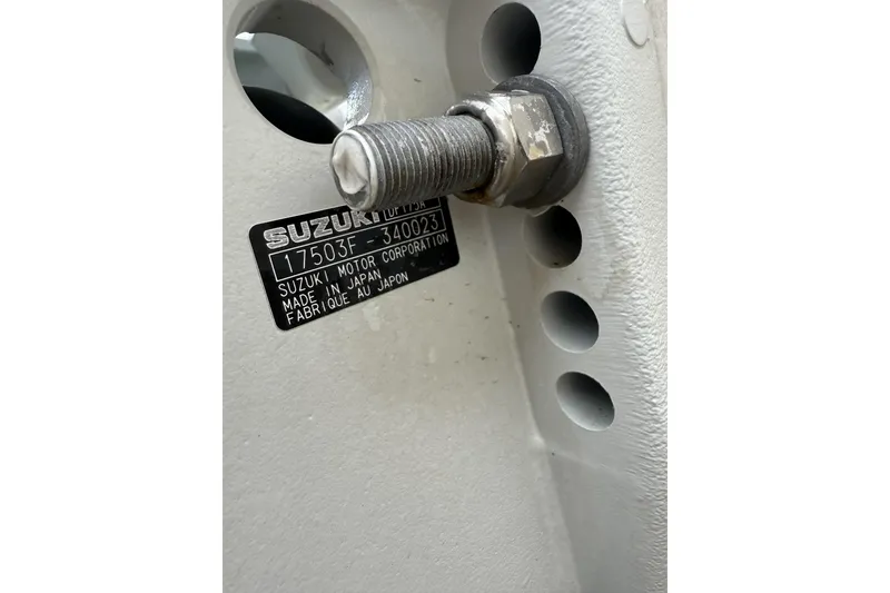 Slide: The Image of Close-up of a Suzuki motor label on a 2023 Pioneer 220 Bay Sport boat. - 5