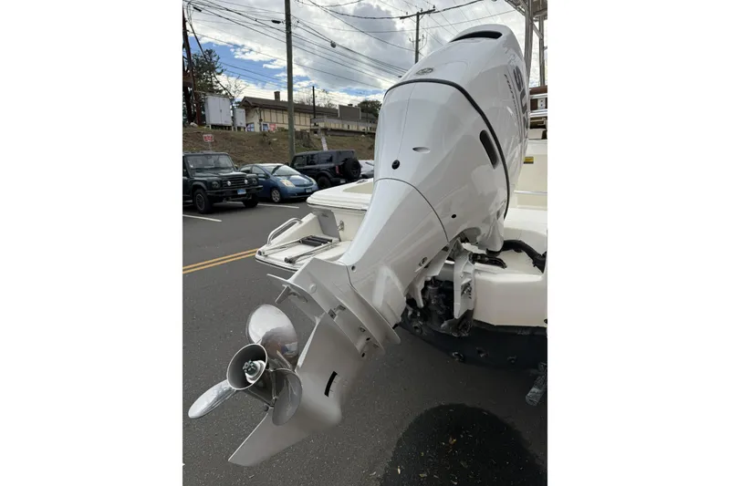 Slide: The Image of 2023 Pioneer 220 Bay Sport boat with powerful outboard motor on a street. - 6