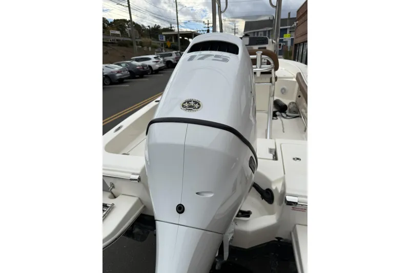 Slide: The Image of 2023 Pioneer 220 Bay Sport boat with powerful 175 horsepower engine, parked on street. - 7