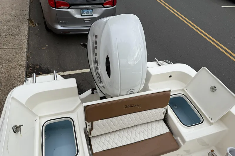 Slide: The Image of 2023 Pioneer 220 Bay Sport boat with Suzuki outboard motor, parked near a street. - 8
