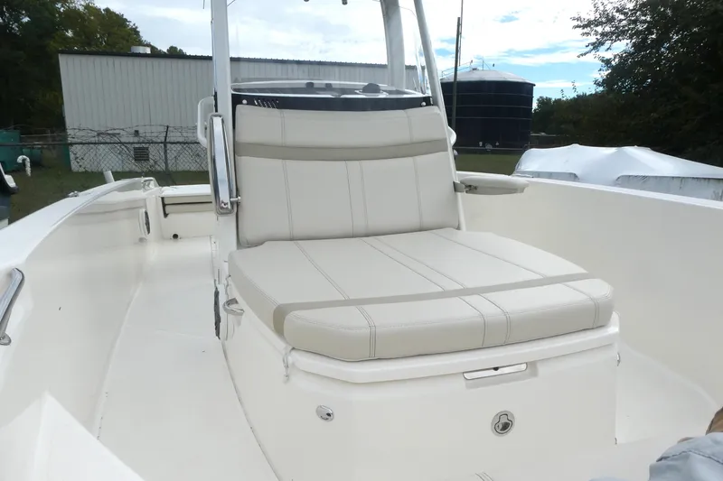 Slide: The Image of 2024 Boston Whaler 220 Dauntless boat interior with cushioned seating. - 12