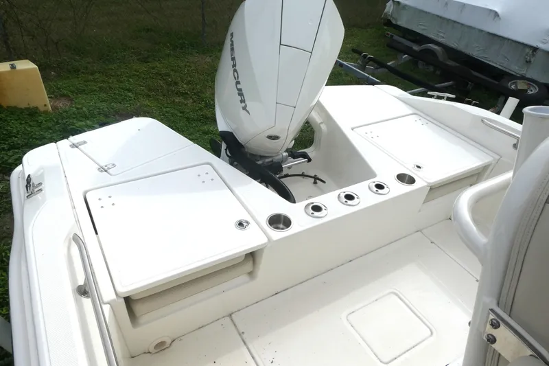 Slide: The Image of 2024 Boston Whaler 220 Dauntless boat with Mercury engine, featuring spacious deck layout. - 4