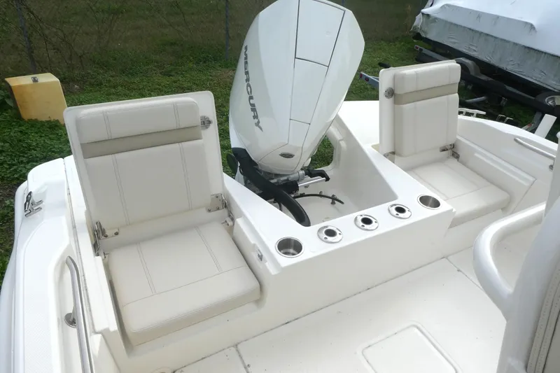 Slide: The Image of 2024 Boston Whaler 220 Dauntless boat interior with Mercury engine and seating. - 5