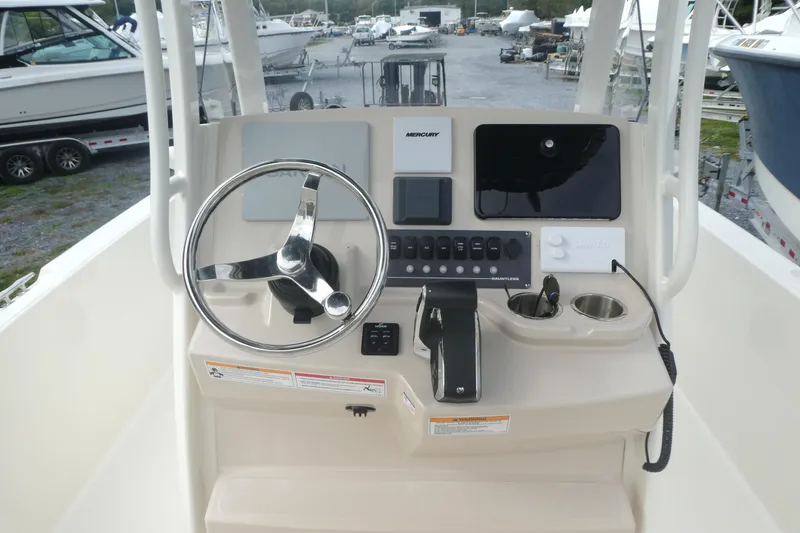 Slide: The Image of 2024 Boston Whaler 220 Dauntless boat console with steering wheel and controls. - 6