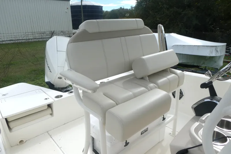 Slide: The Image of 2024 Boston Whaler 220 Dauntless boat seat with white upholstery and armrests. - 7