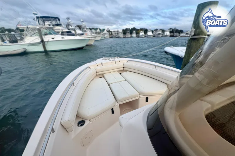 Slide: The Image of 2015 Grady-White Fisherman 209 boat interior with cushioned seating at marina. - 3