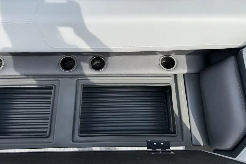 Slide: The Image of 2026 Sun Tracker Party Barge 18 DLX interior with cup holders and storage compartments. - 12