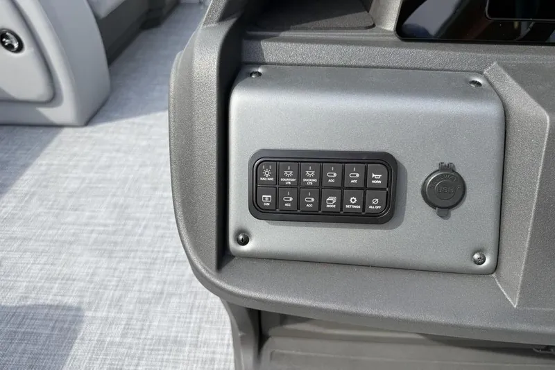 Slide: The Image of Control panel of 2026 Sun Tracker Party Barge 18 DLX with various switches and USB port. - 19