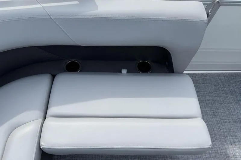 Slide: The Image of 2026 Sun Tracker Party Barge 18 DLX seating with cup holders and gray upholstery. - 22