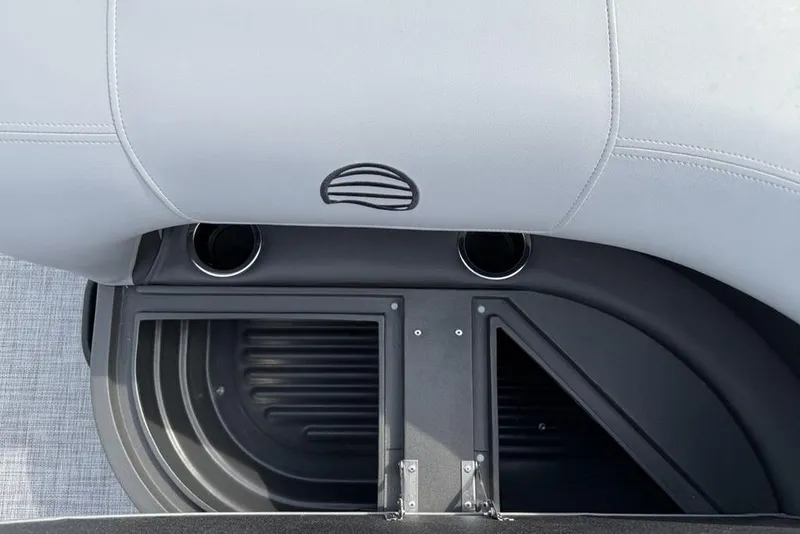 Slide: The Image of Sun Tracker Party Barge 18 DLX 2026 interior seating with cup holders and storage compartment. - 23