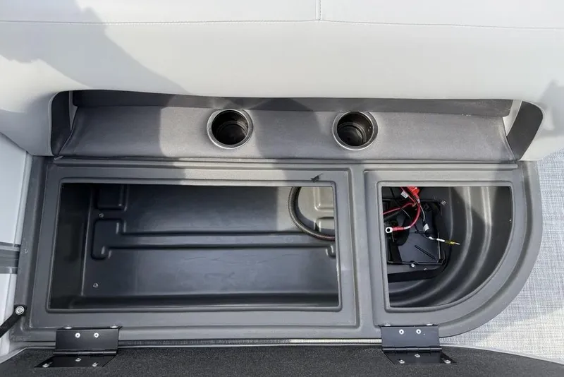 Slide: The Image of Storage compartment of 2026 Sun Tracker Party Barge 18 DLX with cup holders and battery space. - 25