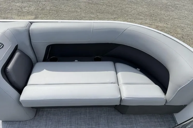 Slide: The Image of 2026 Sun Tracker Party Barge 18 DLX, gray seating with cup holders, outdoor setting. - 4
