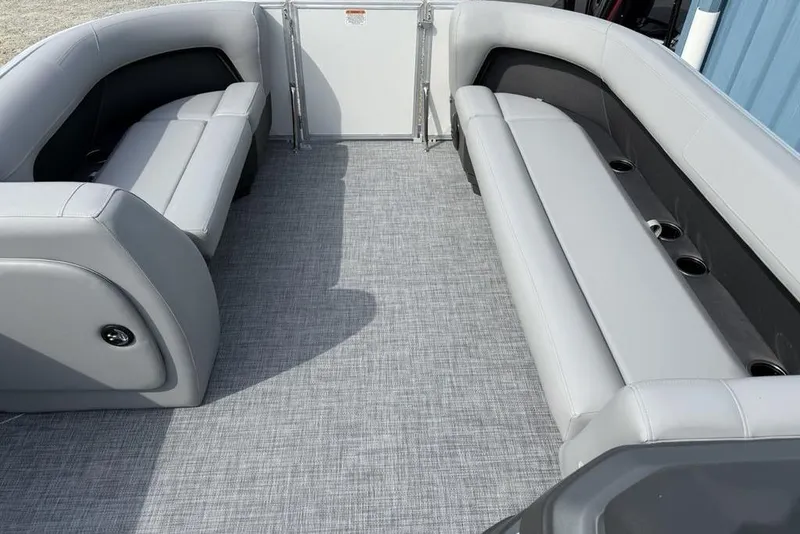 Slide: The Image of 2026 Sun Tracker Party Barge 18 DLX interior with gray seating and flooring. - 5