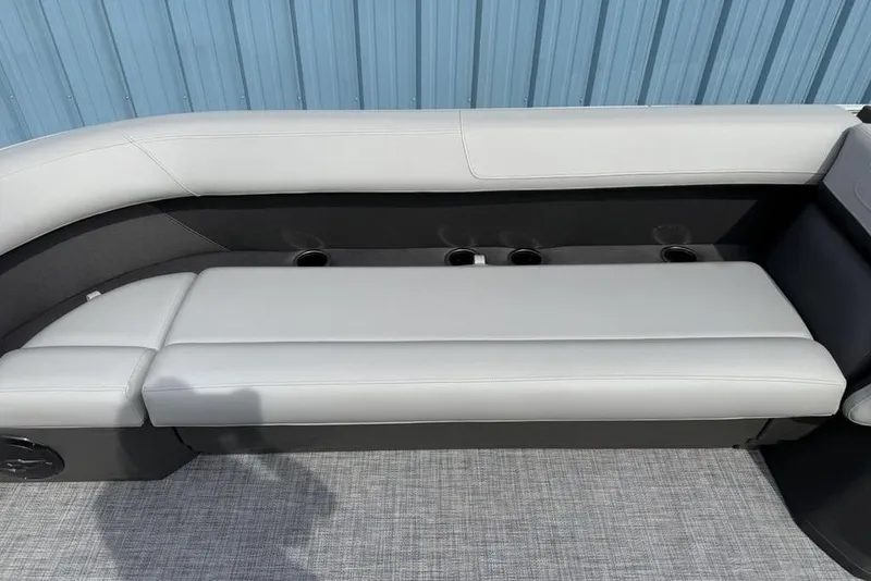 Slide: The Image of 2026 Sun Tracker Party Barge 18 DLX boat seating with cup holders, gray upholstery. - 8