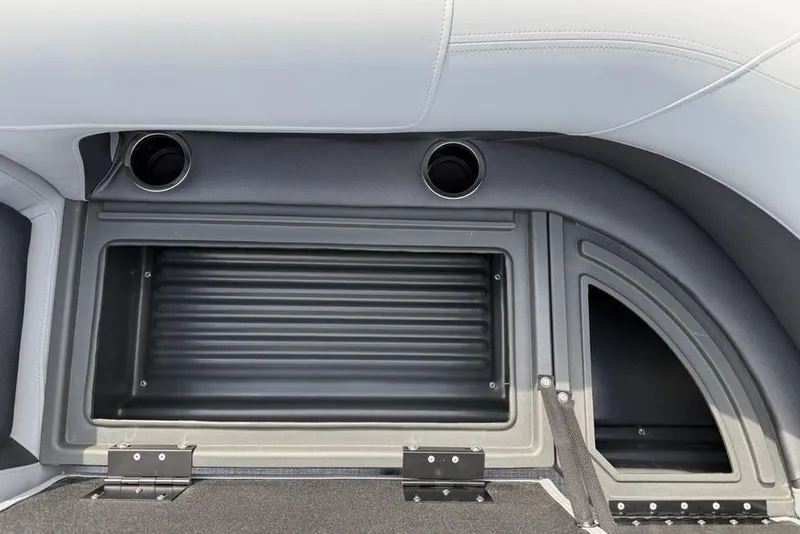 Slide: The Image of 2026 Sun Tracker Party Barge 18 DLX storage compartment with cup holders and sleek design. - 9