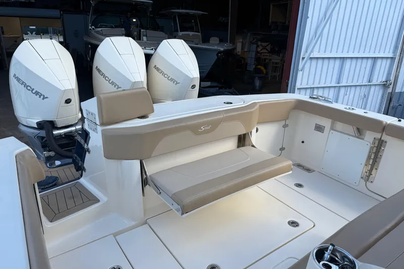 Slide: The Image of 2022 Scout 355 LXF boat with triple Mercury engines and beige seating. - 11