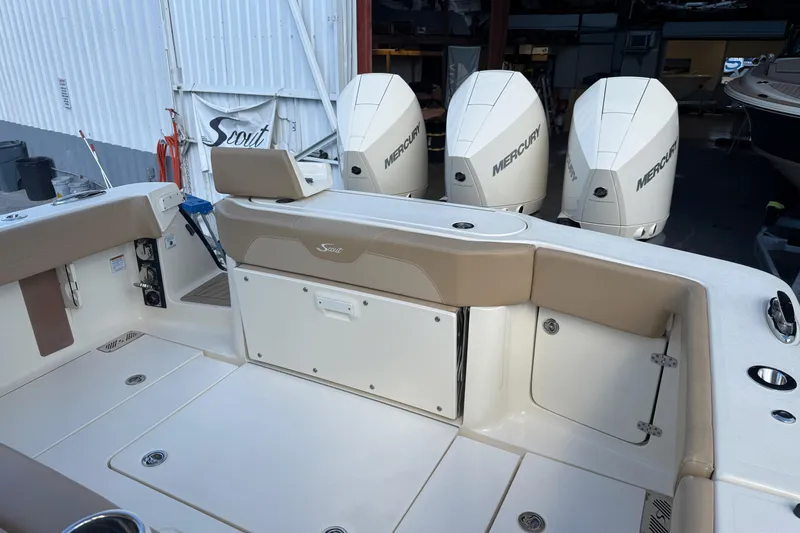 Slide: The Image of 2022 Scout 355 LXF boat with Mercury engines in a marina setting. - 13