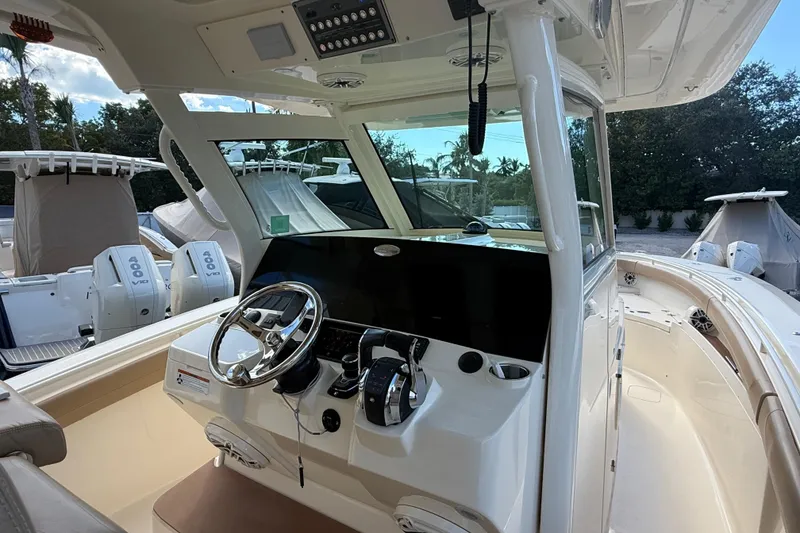 Slide: The Image of 2022 Scout 355 LXF boat interior with steering wheel and control panel. - 18