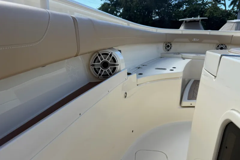 Slide: The Image of 2022 Scout 355 LXF boat interior with speakers and seating, showcasing luxury design. - 25