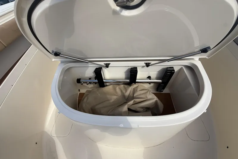 Slide: The Image of Open storage compartment on 2022 Scout 355 LXF boat, showing interior contents. - 35