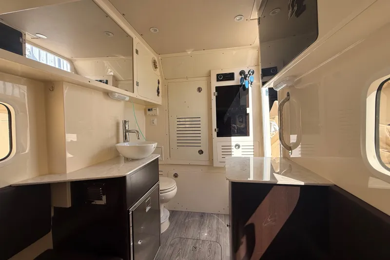Slide: The Image of Interior of 2022 Scout 355 LXF boat featuring modern bathroom amenities and sleek design. - 39