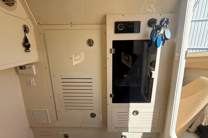 Slide: The Image of Interior view of a 2022 Scout 355 LXF boat, featuring control panels and storage compartments. - 40