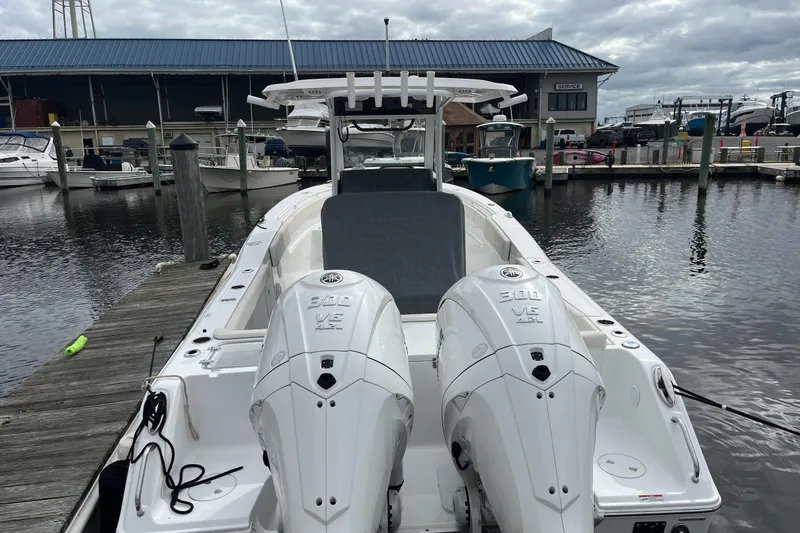 Slide: The Image of 2024 Sea Hunt Gamefish 30 Forward Seating boat docked with twin engines. - 10