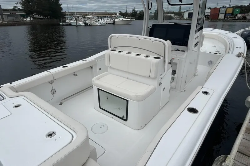 Slide: The Image of 2024 Sea Hunt Gamefish 30 Forward Seating boat docked by the water. - 12