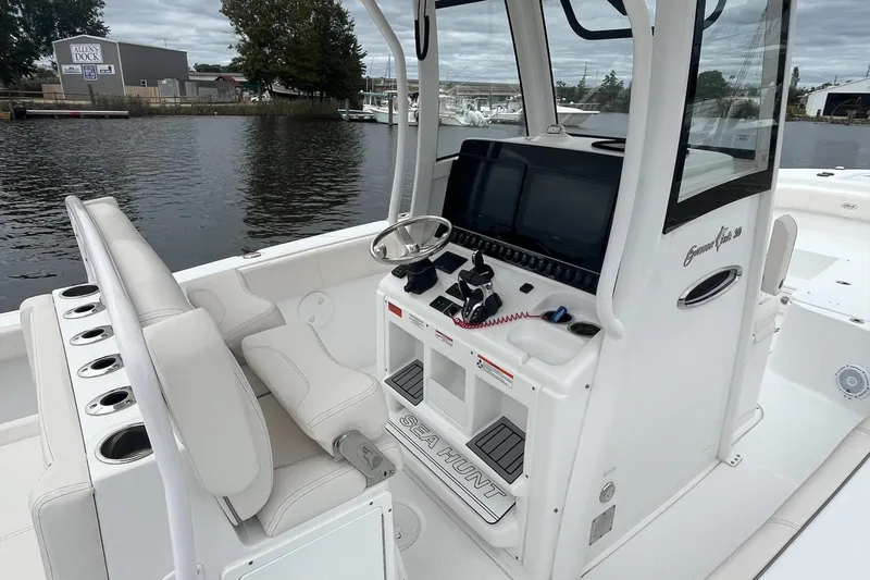 Slide: The Image of 2024 Sea Hunt Gamefish 30 Forward Seating boat interior with helm and seating. - 13