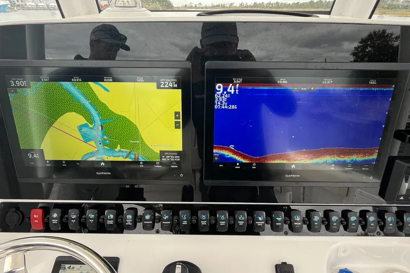Slide: The Image of 2024 Sea Hunt Gamefish 30 dashboard with dual Garmin navigation displays. - 17
