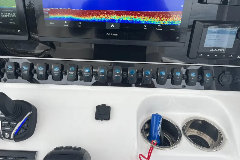 Slide: The Image of 2024 Sea Hunt Gamefish 30 dashboard with Garmin display and control switches. - 19