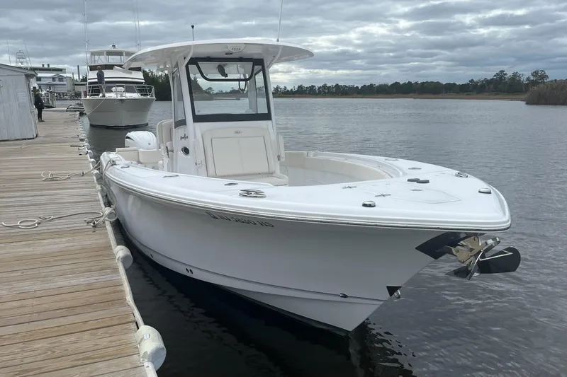 Slide: The Image of 2024 Sea Hunt Gamefish 30 Forward Seating boat docked on a cloudy day. - 4