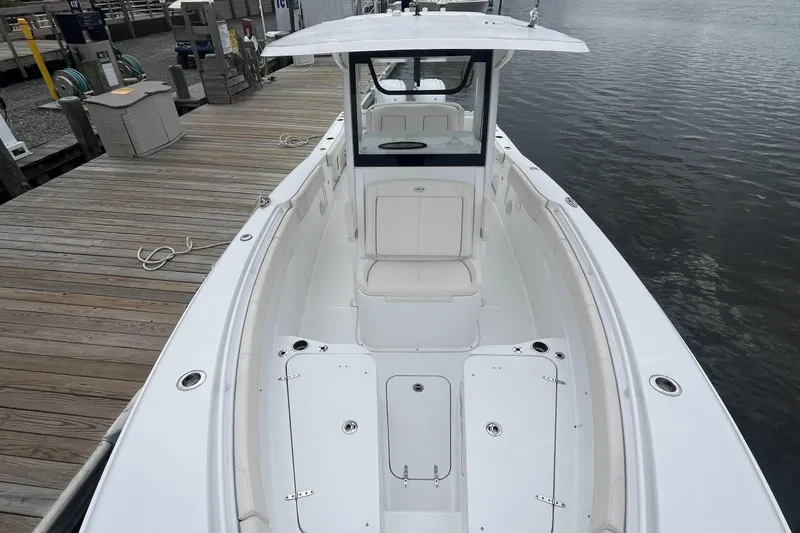 Slide: The Image of 2024 Sea Hunt Gamefish 30 Forward Seating boat docked by the water. - 8