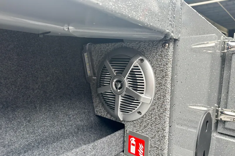 Slide: The Image of Interior of 2026 Lund 210 Heavy Gauge boat with speaker and fire extinguisher sign. - 11