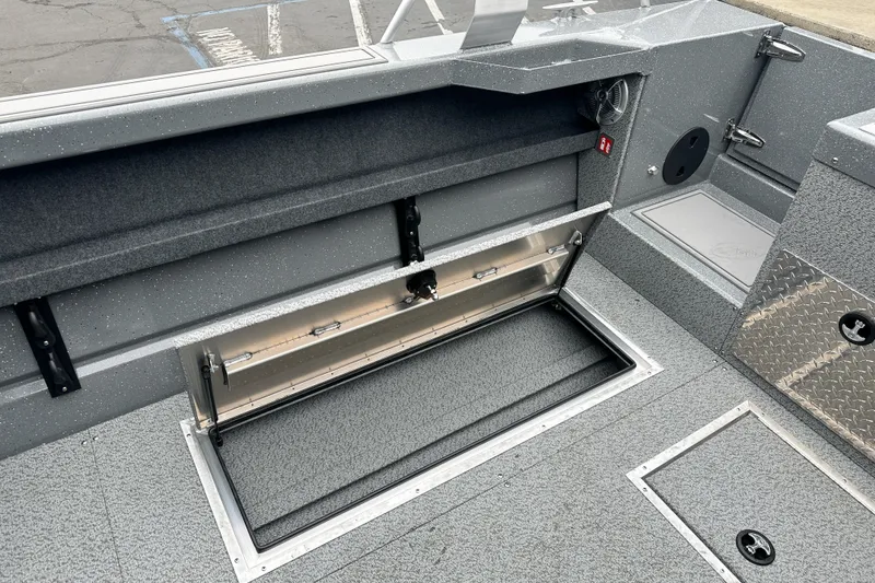 Slide: The Image of 2026 Lund 210 Heavy Gauge boat interior with open storage compartment. - 12