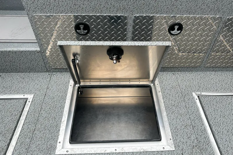Slide: The Image of Open storage compartment on 2026 Lund 210 Heavy Gauge boat with diamond plate accents. - 13