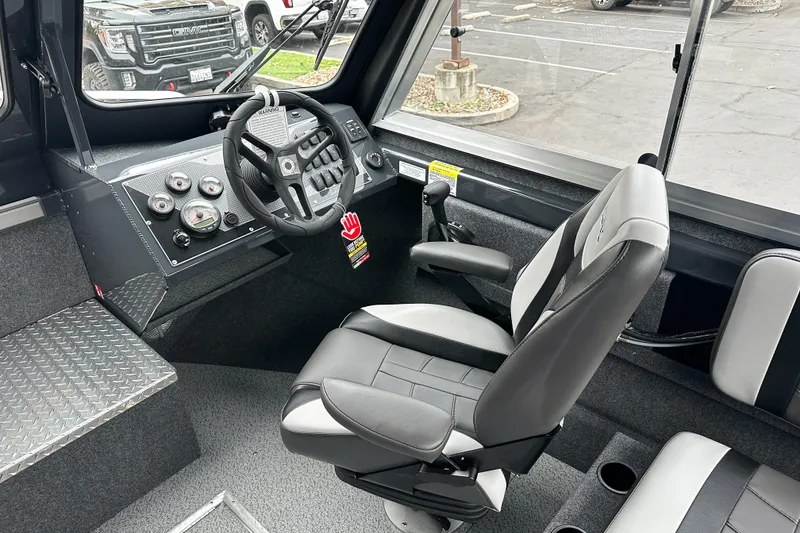 Slide: The Image of Interior of 2026 Lund 210 Heavy Gauge boat with steering wheel and control panel. - 18